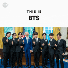 a group of men in suits pose for a picture with the words this is bts on the bottom