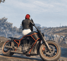 a woman sits on a black and orange motorcycle with a harley davidson logo on it