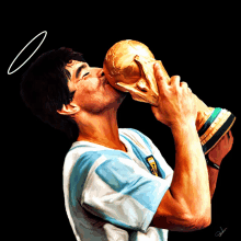 a man with a halo on his head is kissing a soccer trophy