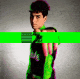 a man wearing a green and black shirt that says shake