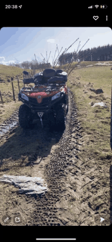 a phone screen shows a red atv on a muddy road