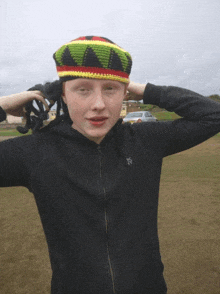 a boy wearing a black jacket with a star on the front