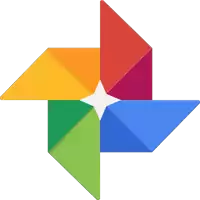 a rainbow colored pinwheel with a white center on a white background