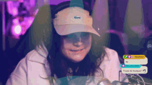 a woman wearing a hat with a lacoste logo