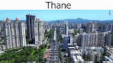 an aerial view of a city with lots of tall buildings and trees