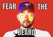 a man with a beard wearing a blue jays hat