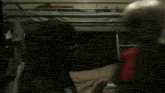 a person is laying in a bunk bed with a green stuffed animal on their back .