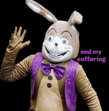 a mascot in a bunny costume is waving at the camera .