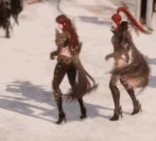 two women are walking in the snow and one has a red ponytail on her head