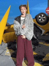 a person wearing a fur coat and a t-shirt that says whist if i can ecg
