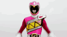 a pink power ranger is wearing a heart shaped helmet and gloves