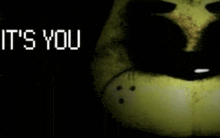 a close up of a yellow teddy bear with the words `` it 's you '' written on it .
