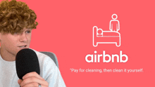 a man is holding a microphone in front of an airbnb ad