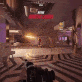 a person is holding a gun in a video game while another person shoots a laser .