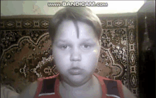 a boy is looking at the camera with the words www.bandicam.com visible in the corner