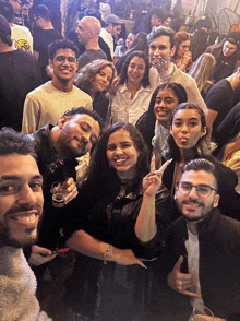 a group of people posing for a picture in a crowded area