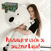 a woman holding a large teddy bear with the words poszukamy osób do druzyny kasix