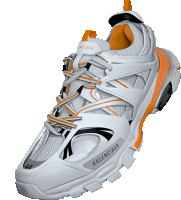 a pair of white balenciaga sneakers with orange accents