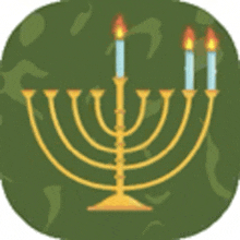 a menorah with three lit candles on a green background .