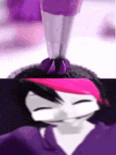a close up of a person 's face with a pink headband and a purple object in the background .