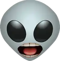 a grey alien face with black eyes and a red tongue