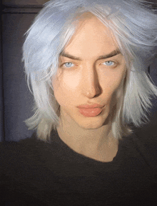 a man with very long white hair and blue eyes