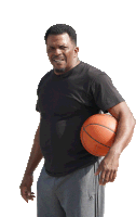 a man holding a basketball wearing adidas pants