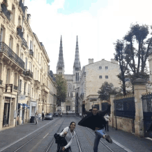 a man and woman are posing for a picture in front of a building with a sign that says ' chinese '