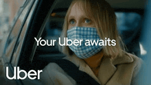a woman is wearing a mask while driving an uber .