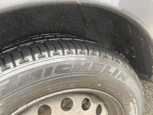 a close up of a michelin tire on a gray car