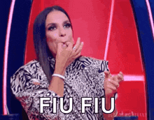 a woman in a leopard print shirt is making a funny face and says fiu fiu