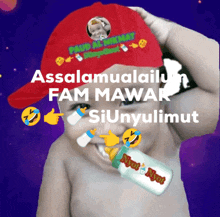 a baby wearing a red hat with the words assalamualaikum fam mawar siunyulmut on it