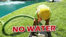 a man in a yellow hard hat is working in the grass with the words " no water " written above him