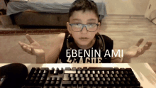 a boy wearing glasses and headphones sitting in front of a keyboard with the words ebenin ami written on the bottom