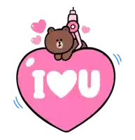 a brown bear sitting on top of a pink heart that says i love you