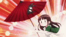 a girl holding a red umbrella with a black rabbit on it