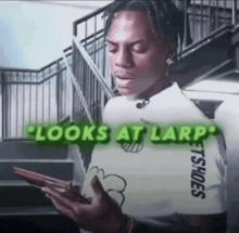 a man is looking at his phone with the words looks at larp behind him