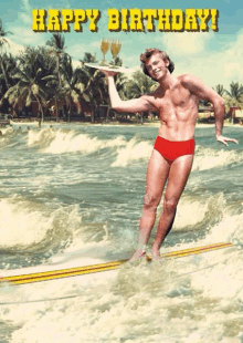 a happy birthday card with a man on a surfboard holding two wine glasses