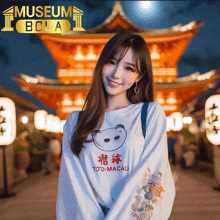 a woman wearing a toto macau shirt stands in front of a building