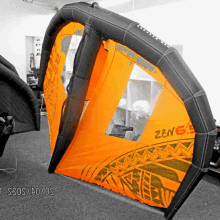 a large orange and black tent with the word zeng on it