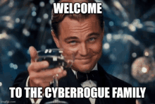 a man in a tuxedo is holding a glass of wine and the caption welcome to the cyberrogue family