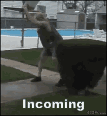 a gif of a person jumping in front of a pool with the words incoming