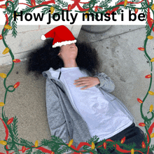 a person wearing a santa hat laying on the ground