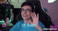 a young man wearing glasses and headphones is saying hi there