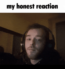 a man wearing headphones with the words " my honest reaction " above him