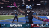 a football player celebrates a touchdown during a game on espn