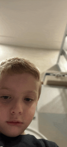 a young boy is taking a selfie in a bathroom