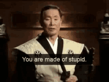 an old man in a kimono is holding a sword and saying `` you are made of stupid '' .