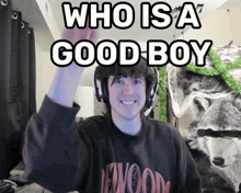 a man wearing headphones with the words who is a good boy behind him