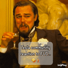 a man in a suit is holding a glass of wine and says tesla community reaction to fud ...